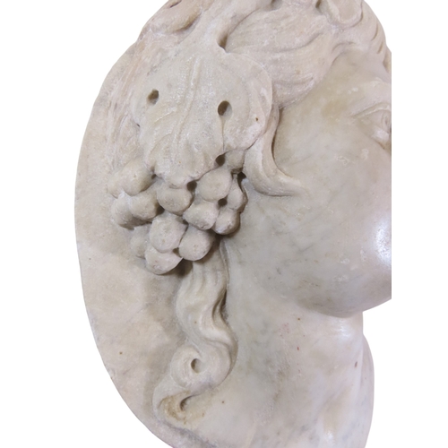 42 - A well carved antique white marble relief bust, study of a maiden, her hair in ringlets and adored w... 