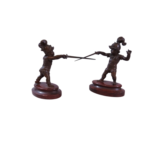 9 - A pair of 19th century continental bronze figures, humorous opposing dueling infants presented with ... 