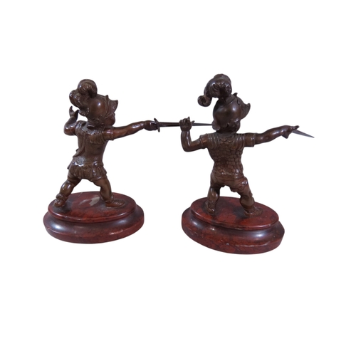 9 - A pair of 19th century continental bronze figures, humorous opposing dueling infants presented with ... 
