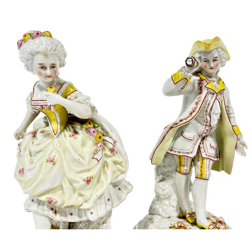 39 - A pair of 19th century continental porcelain figures of male and female characters with floral patte... 