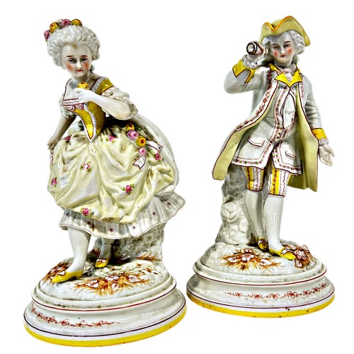 39 - A pair of 19th century continental porcelain figures of male and female characters with floral patte... 