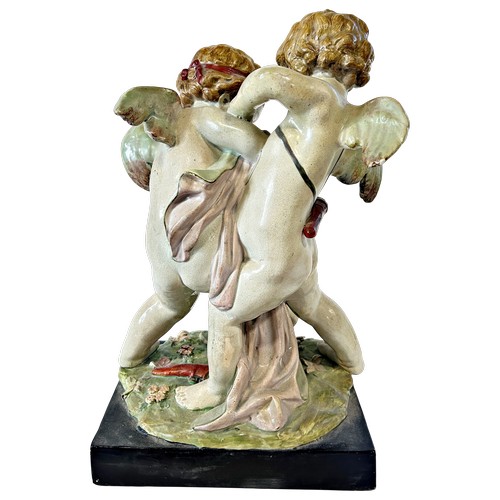 53 - A 19th century pottery group showing Eros tussling with Anteros, attributed to Enoch Wood, 38cm high