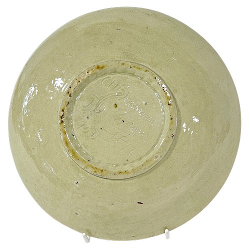 37 - C.H. Brannam plate by James Dewdney, monogrammed and dated 1892, depicting a stylised bird amongst f... 