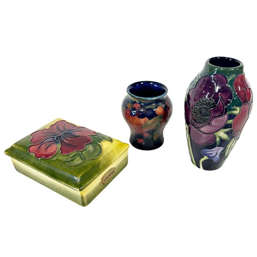 40 - Three pieces of Moorcroft comprising Anemone vase, 12cm high, a Pomegranate vase and a Hibiscus trin... 