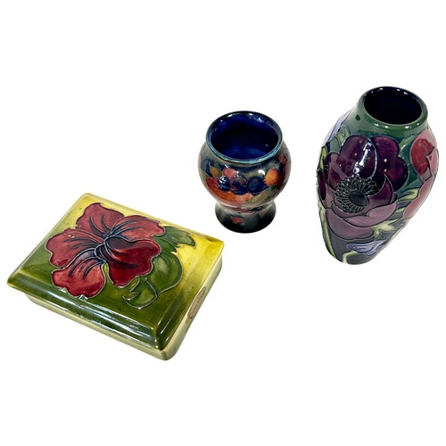 40 - Three pieces of Moorcroft comprising Anemone vase, 12cm high, a Pomegranate vase and a Hibiscus trin... 