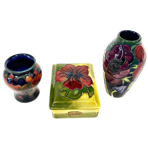 40 - Three pieces of Moorcroft comprising Anemone vase, 12cm high, a Pomegranate vase and a Hibiscus trin... 