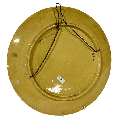 44 - A late 19th century pottery wall plate with hand painted detail showing water nymphs within a sunflo... 