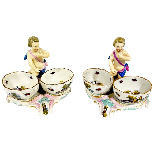 47 - A pair of 19th century Meissen double salts with cherub mounts and polychrome decoration of flowers ... 