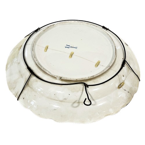 48 - A 19th century Meissen porcelain charger with central panel depicting a blacksmith with horse and ri... 