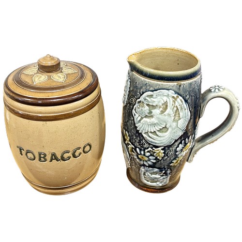 doulton lambeth tobacco jar A Doulton Lambeth tobacco jar and cover and further Lambeth ware jug with  exotic bird and floral dec