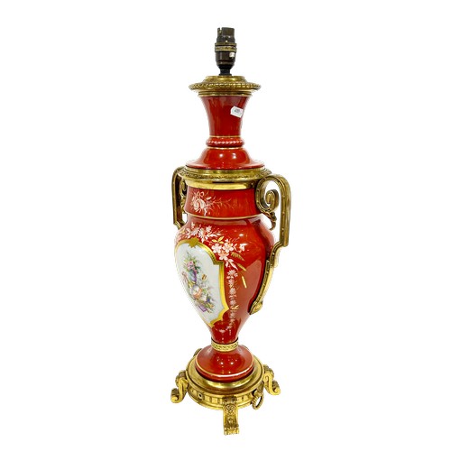 49 - A large continental porcelain lamp base with gilt handles and base, the brick red ground enclosing f... 