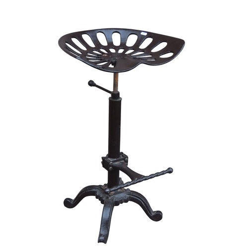 A pair of cast iron tractor seat bar stools