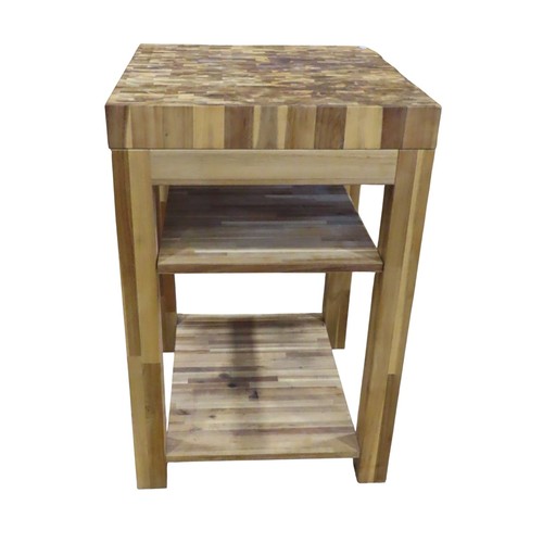A contemporary kitchen butchers block on stand of square cut form, with ...