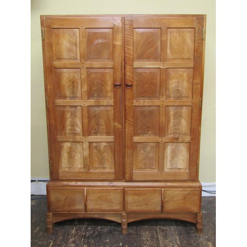 1523 - A fine quality Cotswold school fitted wardrobe in pale English walnut, the panelled frame enclosed b... 
