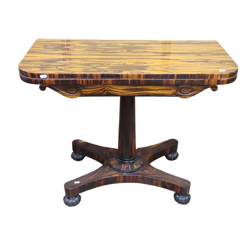 1524 - A 19th century fold over top card table, veneered in coromandel, raised on simple turned pillar with... 