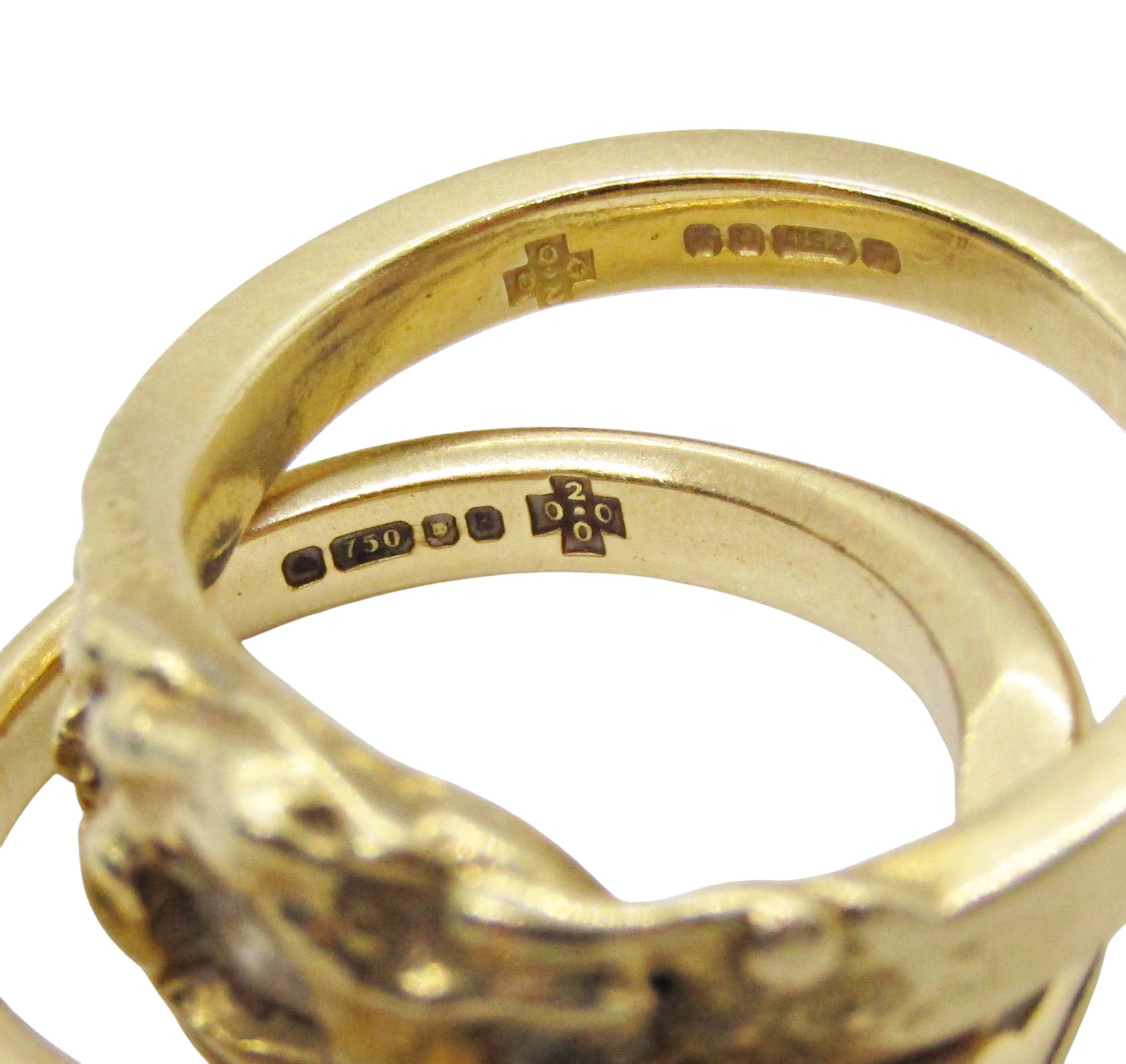 A pair of 18ct yellow gold rings of textured organic inter-fitting form ...