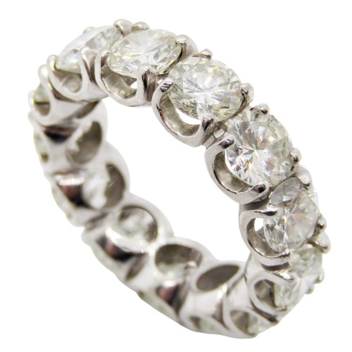 Attributed to Boodle & Dunthorpe. An impressive white metal mounted diamond eternity band ring, formed from thirteen round brilliant cut diamonds, approximate total diamond weight 7.34ct size L/M, 9.5g