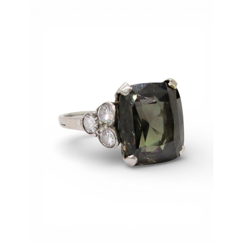 An exceptional Art Deco period natural Alexandrite dress ring, with single fancy cushion cut stone, 7.0ct approx,  mounted in unmarked white metal (previously described as platinum) with three brilliant cut diamonds set in trefoil motifs to shoulders, size K, 4.2g

Sold with historic insurance valuation by Carrington & Company Ltd, 130 Regent Street, London W1 dated 15/7/1970 listing a figure of £3,300 and later Sotheby’s valuation / sale entry report, offering to consign the ring for sale in the Important Jewels sale, 21st June 2001 in Bond Street, London with an estimate of £10,000 - £12,000. (The family ultimately decided to keep the ring at this time).

Property of a private Gloucestershire lady, this ring known to have been present in the same family since the late 19th century and has never before been presented to the market:

This Alexandrite stone is understood by family repute to have been brought back from the Ural mountains in Russia in 1895 by a military attaché aide-de-camp on secondment and gifted to his wife (our vendor’s grandmother, nee Eileen Reeves of Besborough,
Ireland).  

The attaché sadly died soon afterwards. Some time later, Eileen married our vendor’s grandfather, C Pickering, who later became Duke of Wellington. 

The stone was set into a ring in the mid to late 1920’s and has remained unchanged since, in unbroken ownership of the same family until consignment here.