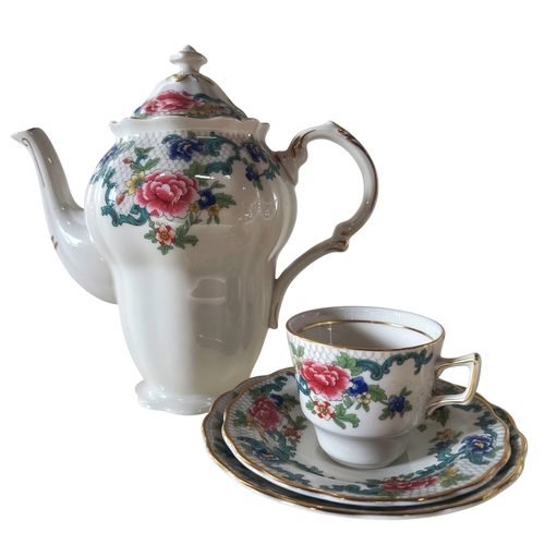 10 - A collection of Booths Flora Dora tea and coffee ware, with two pots, cups and saucers (two shapes)