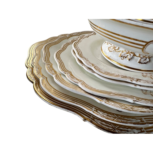 9 - A 19th century part dinner service, in white with gilded borders and armorial crest, comprising: gra... 