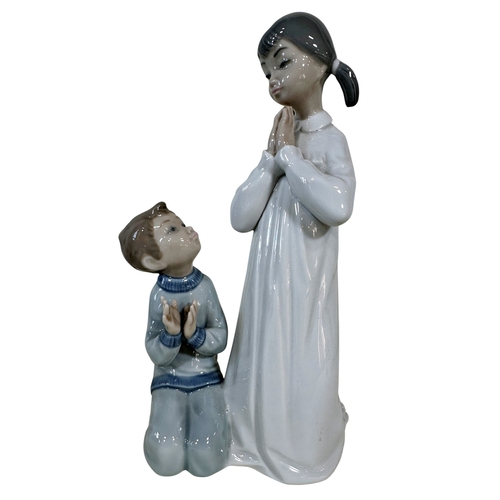 26 - Seven Lladro figures, angels, children with puppies, etc