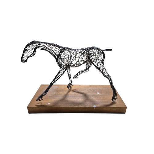 713 - A contemporary abstract wirework horse sculpture on wooden base, 51cm long