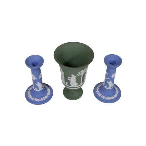 13 - A pair of blue Wedgwood Jasperware candlesticks, together with a campana shaped green Wedgwood vase,... 