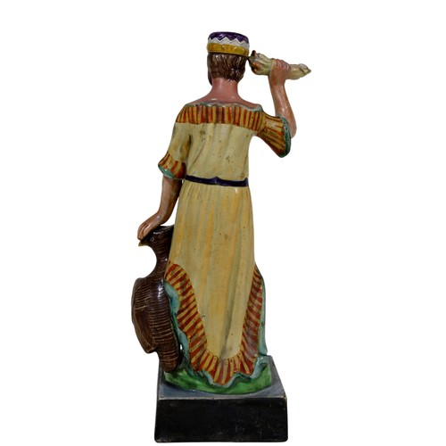 20 - A 19th century Staffordshire pearlware figure, modelled as Jupiter with crown, attendant eagle at hi... 