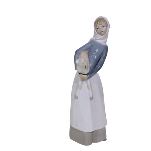 22 - A group of four Lladro figures, to include 