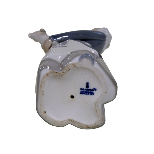 22 - A group of four Lladro figures, to include 