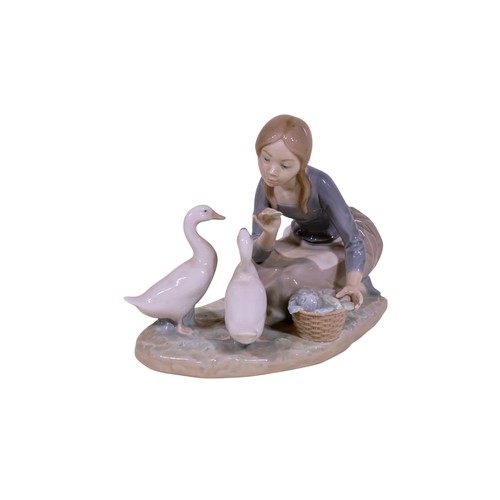 22 - A group of four Lladro figures, to include 