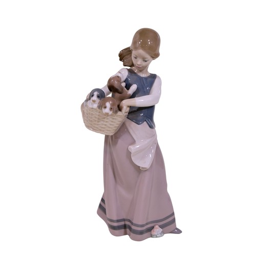 22 - A group of four Lladro figures, to include 