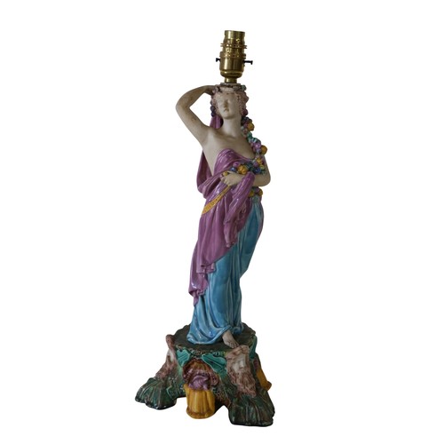 46 - A pair of 19th century Majolica comport stands, male and female characters each holding a cornucopia... 