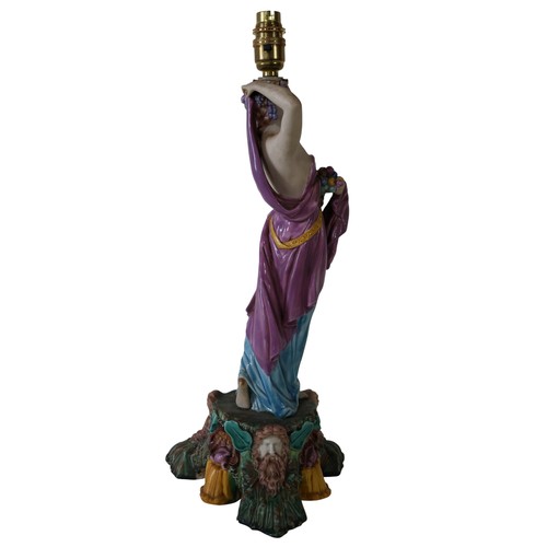 46 - A pair of 19th century Majolica comport stands, male and female characters each holding a cornucopia... 