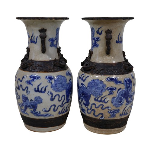 49 - A pair of Chinese blue and white baluster shaped vases, with temple lion, cloud, fire and other deta... 