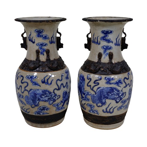 49 - A pair of Chinese blue and white baluster shaped vases, with temple lion, cloud, fire and other deta... 