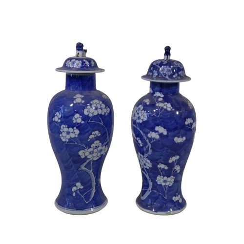 57 - A pair of late 19th century, Chinese blue and white porcelain prunus vases of baluster form, with do... 