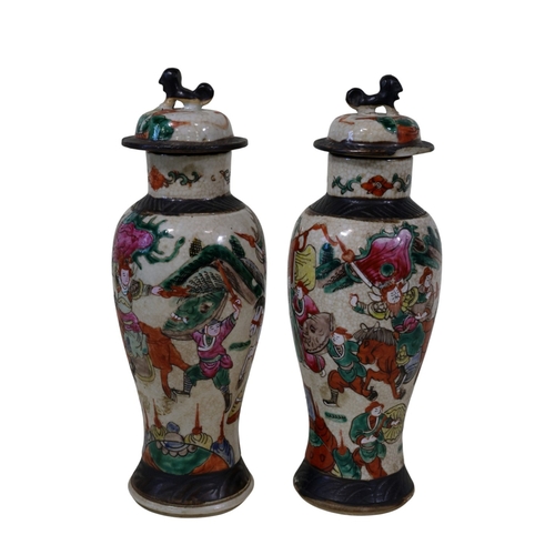 58 - A pair and another 19th century Chinese famille rose crackleware 'warrior' vases, pair with covers a... 