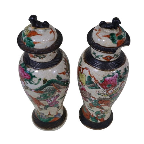 58 - A pair and another 19th century Chinese famille rose crackleware 'warrior' vases, pair with covers a... 