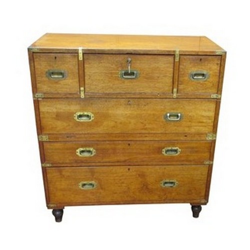 A mid 19th century two sectional campaign secretaire chest of three long and two short drawers, the central secretaire with fitted interior, brass banded, labelled 'York House, 15 Regent St. London', 109cm high, 99cm wide, 48cm deep