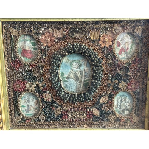 34 - A reliquary frame, 18th-early 19th century, paper filigree scroll work with hand-coloured engravings... 