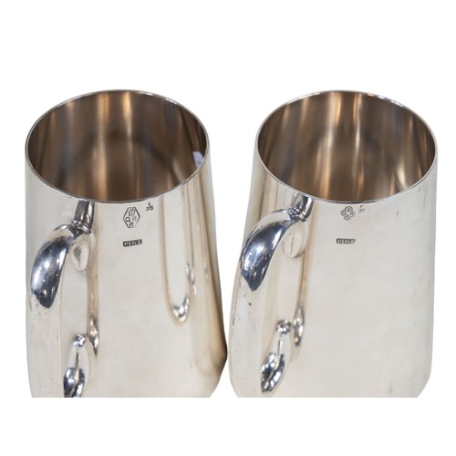 303 - A pair of Mappin & Webb silver plated pint tankards, monogrammed, together with a pair of Victorian ... 