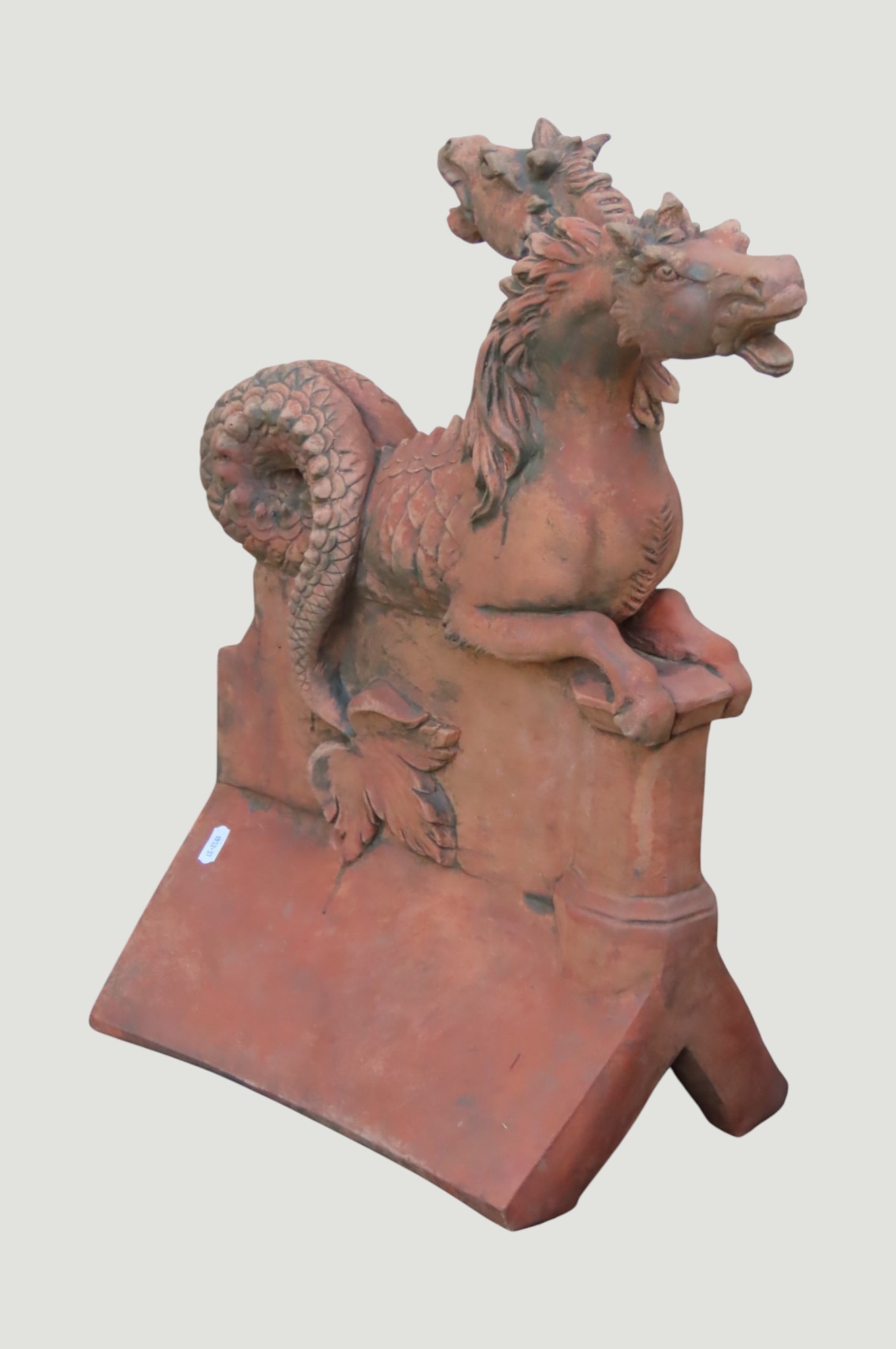 A decorative composition stone Janus ridge tile (twin headed mythical ...