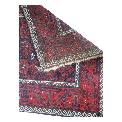 1565 - An eastern wool rug, principally in Red & Black within running borders 150cm x 90cm