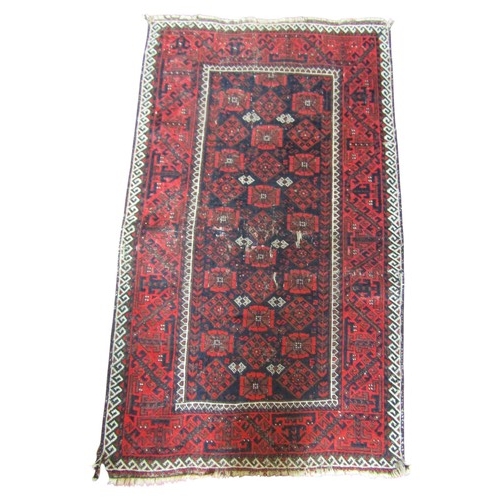 1565 - An eastern wool rug, principally in Red & Black within running borders 150cm x 90cm