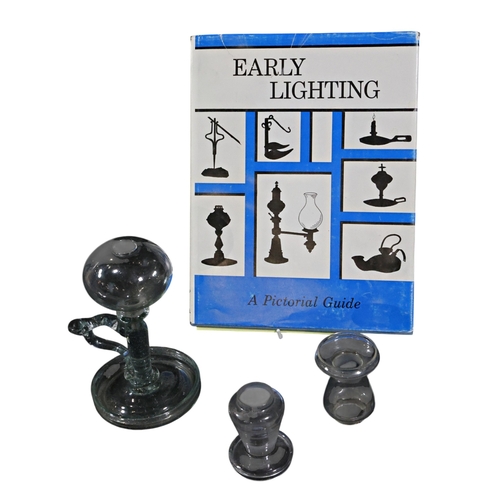 284 - An 18th/19th century glass lacemakers lamp, two Hychnophylax glasses and a book on early lighting, a... 