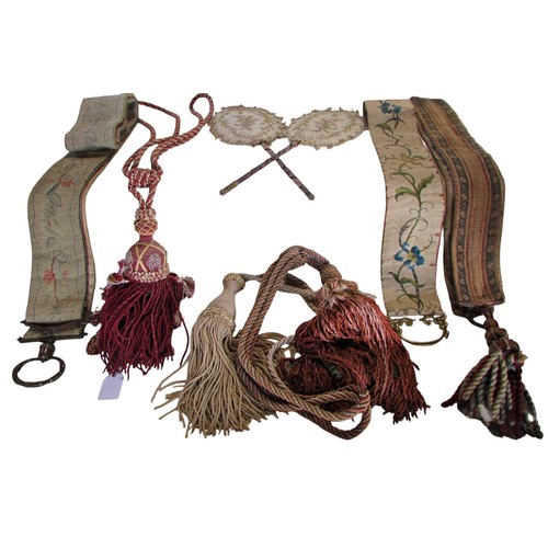 710 - Quantity of tassels, tapestry bell pull with brass ring handles, two handworked face screens