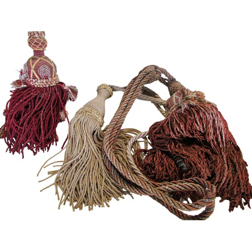 710 - Quantity of tassels, tapestry bell pull with brass ring handles, two handworked face screens
