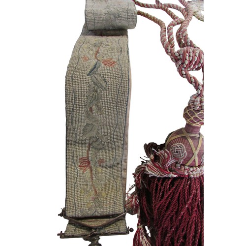 710 - Quantity of tassels, tapestry bell pull with brass ring handles, two handworked face screens