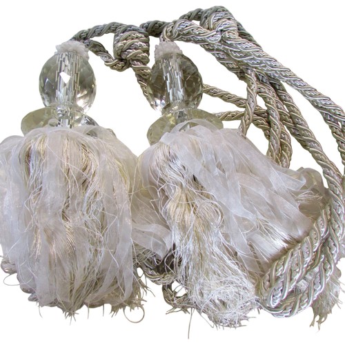 710 - Quantity of tassels, tapestry bell pull with brass ring handles, two handworked face screens